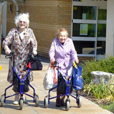 shopping no longer a chore Two people pushing three wheeled buggies